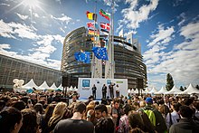 European Parliament opening in Strasbourg with crowd and many countries' flags on flagpoles