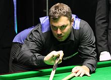 Kurt Maflin playing a shot with the rest