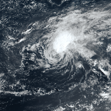 Satellite image of a cyclone where the thickest clouds are displaced from the central vortex