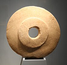 Round tan stone with hole at center