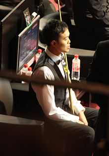Photograph of Marco Fu sitting at the 2011 German Masters