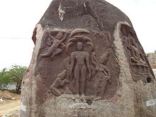 Outdoor stone relief of Parshvanatha, carved into a boulder