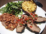 Santa Maria-style barbecue: Tri-tip with salsa, pink beans instead of pinquito beans, salad, and garlic bread.