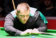 Mark Allen playing a shot with the rest