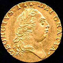 Gold coin bearing the profile of a round-headed George wearing a classical Roman-style haircut and laurel-wreath.