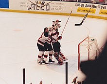 Teammates mob Martin Brodeur moments after the 1995 Stanley Cup Finals