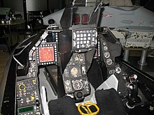 Cramped cockpit of jet trainer, showing dials and instruments