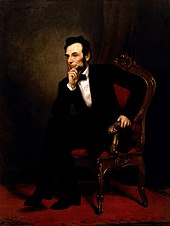 Lincoln sitting with his hand on his chin and his elbow on his leg.