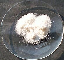 Some fine white powder on a laboratory watch glass