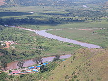 Photograph of confluence of the Kagera and the Ruvubu, with the Rwanda-Tanzania border post in foreground, taken from a nearby hilltop