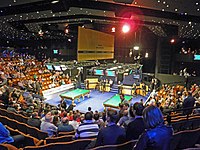 Interior of the Crucible Theatre with two snooker tables in the centre surrounded by seating