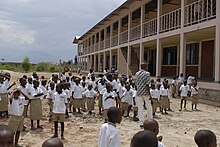 group of children at school in white shirt and khaki shorts uniforms