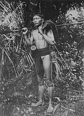 Portrait of a Dayak hunter in Borneo with a boar over his shoulder