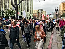 An image of protestors marching down a street in Oakland.
