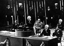 An image of President Truman speaking at a podium, addressing the United Nations Convention.