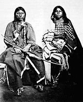 Photograph of a Kiowa couple showing elk teeth on the woman's dress
