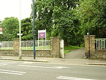 Photograph of an external wall and a gate at the boundary of Westow Park.