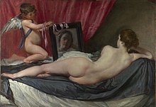 Realistic painting of a nude woman seen from behind, reclining on a couch. She is looking at her reflection in a mirror held by a winged child.