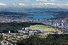 Aerial picture of the Hönggerberg campus. The city of Zurich and the Alps can be seen behind.