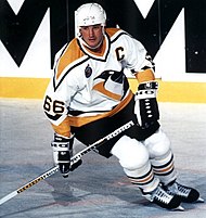 Photograph of Mario Lemieux holding a stick and skating