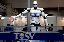 Photograph of a TOPIO humanoid ping-pong-playing robot