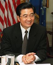 Bespectacled Asian man in suit