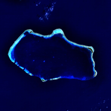 A blue colored image of an atoll.