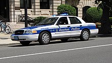 White Boston Police car with blue and gray stripes down the middle