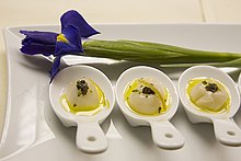 Three small dishes, with an iris above for decoration, on larger rectangular plate