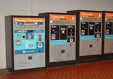 A row of fare-card machines, each with buttons, slots for money and farecards, and printed instructions.