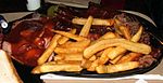 "Combo plate" of several Kansas City-style barbecue dishes and French fries