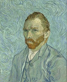 Un retrato de cabeza y hombros de un hombre de treinta y tantos años, con barba roja, mirando hacia la izquierda.