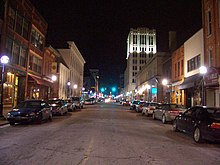 Night time in downtown, with buildings lit by street lamps