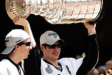 Photograph of Sidney Crosby with Marc-Andre Fleury holding the Stanley Cup in 2009.