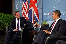 US President Barack Obama and British Prime Minister David Cameron trade bottles of beer to settle a bet they made on the U.S. vs. England World Cup Soccer game (which ended in a tie), during a bilateral meeting at the G20 Summit in Toronto, Canada, Saturday, June 26, 2010.