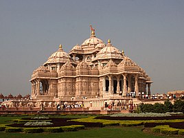 A complete view of Akshardham temple with people entering the temple.