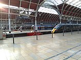 Paddington railway station with sun shining through the arches built by Brunel
