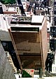 Aerial view of a skyscraper with a trapezoidal cross section and a brown glass exterior
