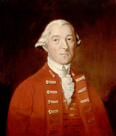 A half-height portrait of Carleton. He wears a red coat with vest, over a white shirt with ruffles. His white hair is drawn back, and he faces front with a neutral expression.