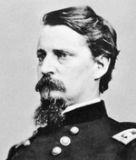 Photo of dark-haired and bearded Winfield S. Hancock in a dark uniform with a determined look