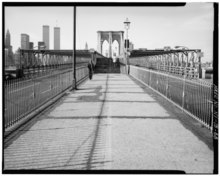 A view of the Brooklyn Bridge in 1982, showing the steps that formerly led to the pedestrian promenade. A suspension tower is located in the background