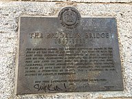 A plaque that certifies the Brooklyn Bridge as a New York City designated landmark