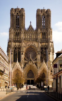 Notre-Dame de Reims façade, gothic stone cathedral against blue sky