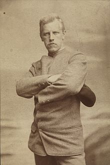 Portrait of a stern and determined looking man with arms crossed.