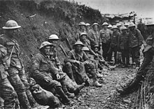 Mud stained British soldiers at rest