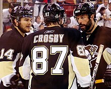 Photograph if Crosy, Bill Guerin and Chris Kunitz talking on ice during a game