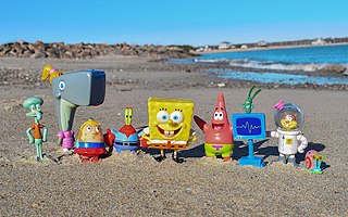 Photograph of a SpongeBob SquarePants figure set on a beach