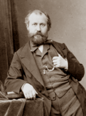 photograph of man in early middle age, balding, with neat moustache and beard